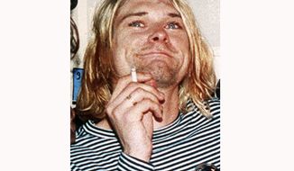 FILE - This 1993 file photo shows Kurt Cobain, the lead singer of the US rock band Nirvana. On Friday, April 5, 2019, people gathered throughout the day at Viretta Parkin in Seattle, leaving flowers, candles and written messages on the 25th anniversary of Cobain&#39;s death. Cobain, whose band Nirvana rose to global fame amid Seattle&#39;s grunge rock years of the early 1990s, shot himself on April 5, 1994 in his home near Lake Washington. (AP Photo/Mark J.Terrill, File)