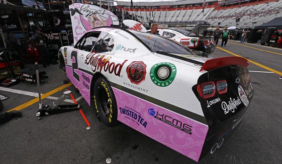 The car of driver Tyler Reddick sits in the pits being worked on after practice for the NASCAR Xfinity Series auto race Friday, April 5, 2019, in Bristol, Tenn. The reigning Xfinity Series champion is piloting a Chevrolet at Bristol covered with country music icon Dolly Parton&#39;s face and her signature butterfly logo.(AP Photo/Wade Payne)