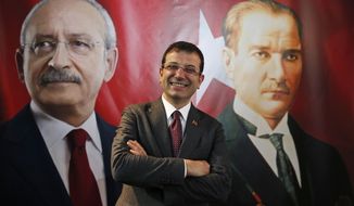 Backdropped by a poster of Kemal Kilicdaroglu, left, the main opposition Republican People&#39;s Party (CHP) leader, and modern Turkey&#39;s founder Mustafa Kemal Ataturk, right, Ekrem Imamoglu, the CHP&#39;s mayoral candidate in Istanbul, poses for The Associated Press following an interview in Istanbul, Thursday, April 4, 2019. Imamoglu said he&#39;s confident that the result of a recount of votes in the city will confirm his victory and has renewed an appeal to Turkey&#39;s President Recep Tayyip Erdogan to help end the standoff. Imamoglu won the tight race for Istanbul in Sunday&#39;s local elections in a major upset for Erdogan, who rose to power as the mayor of the city of 15 million and has said that whoever wins Istanbul wins to whole of Turkey. (AP Photo/Lefteris Pitarakis)