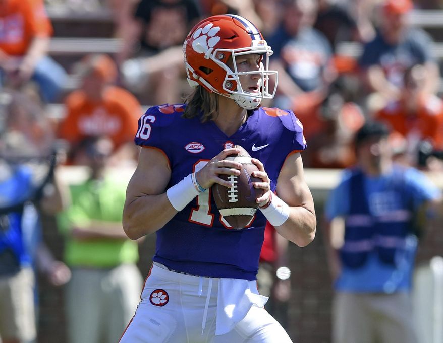Clemson's Trevor Lawrence drops back to pass during Clemson's annual Orange and White NCAA college football spring scrimmage Saturday, April 6, 2019, in Clemson, S.C. (AP Photo/Richard Shiro)