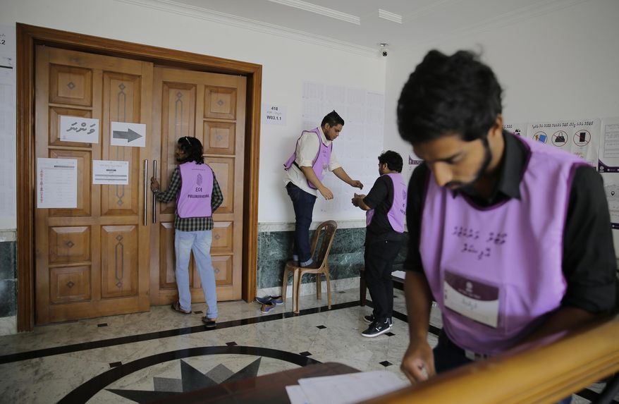 Maldivian polling workers prepare a polling station for expatriates at the Maldivian High Commission in Colombo, Sri Lanka, Saturday, April 6, 2019. Maldives President Ibrahim Mohamed Solih is hoping Saturday's parliamentary elections will help him overcome a coalition split that has hampered his efforts to restore political freedoms and tackle corruption. (AP Photo/Eranga Jayawardena)