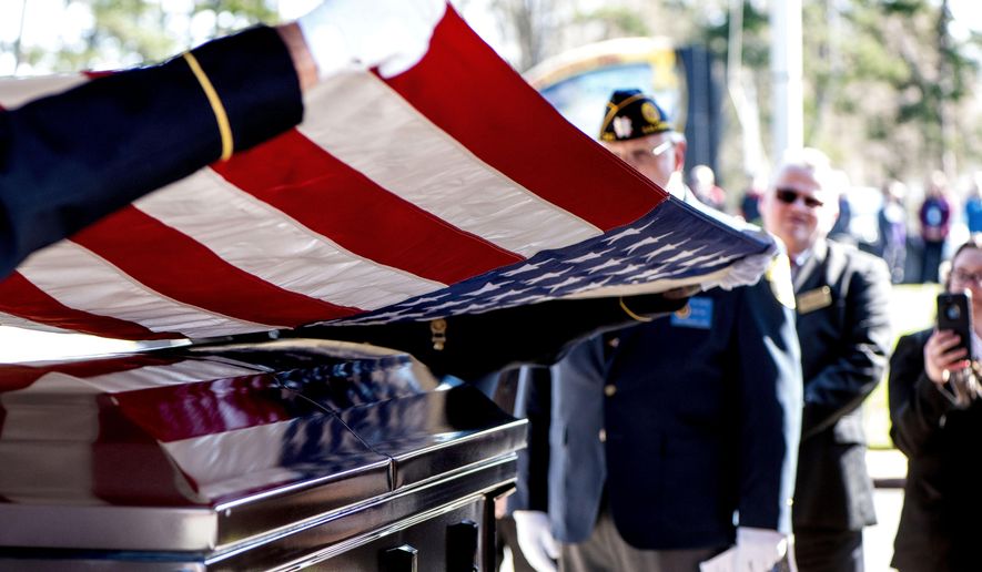 This photo taken April 3, 2019, shows members of the US Army honor guard lifting the American flag off the casket during the burial ceremony at the Salisbury National Cemetery in Salisbury, N.C. US Army medic Phillip Kenneth Drye, a veteran of the Vietnam War, was buried at the Salisbury National Cemetery on Wednesday morning with full military honors. Drye passed away on Dec. 24, 2018, but had no relatives to claim the body and pay for his funeral. (Jon C Lackey/The Salisbury Post via AP)