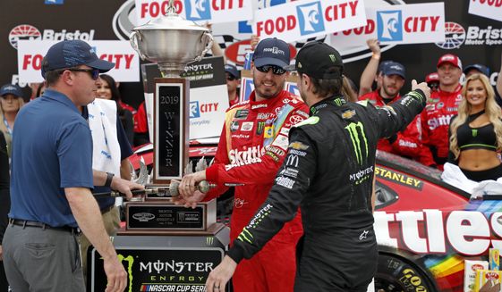 Kyle Busch gets a hug from brother Kurt Busch, right, after winning the NASCAR Cup Series auto race Sunday, April 7, 2019, in Bristol, Tenn.(AP Photo/Wade Payne)