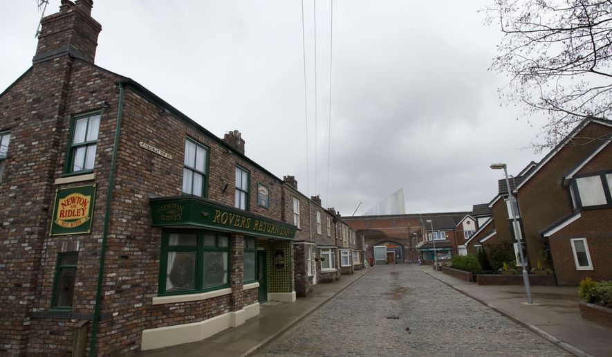 FILE - In this file photo dated Friday, Nov. 29, 2013, the film set of long running British soap opera entitled 'Coronation Street', in Manchester, England. The long running TV series covering an intimate look into the lives of families in the fictional north England town, will introduce its first black family into the series, in its 59-year history, according to an announcement by Producer Iain MacLeod, Sunday April 7, 2019. (AP Photo/Jon Super, FILE)