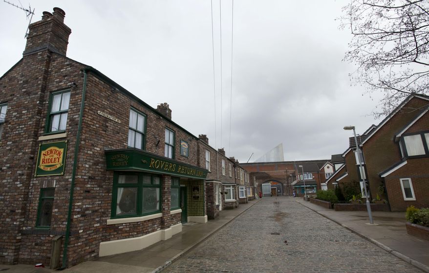 FILE - In this file photo dated Friday, Nov. 29, 2013, the film set of long running British soap opera entitled 'Coronation Street', in Manchester, England. The long running TV series covering an intimate look into the lives of families in the fictional north England town, will introduce its first black family into the series, in its 59-year history, according to an announcement by Producer Iain MacLeod, Sunday April 7, 2019. (AP Photo/Jon Super, FILE)