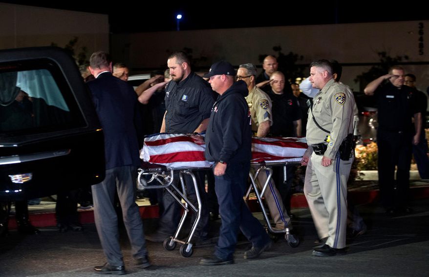 In this Saturday, April 6, 2019 photo, officers escort the remains of fallen California Highway Patrol Sgt. Steve Licon's as it is transferred from the Inland Valley Medical Center to the Perris Coroner in Wildomar, Calif. Motorcycle officer Sgt. Licon was involved in a collision on the I-15 Freeway in Lake Elsinore Saturday afternoon. Michael Callahan of Winchester was booked on the charges in the death of California Highway Patrol Sgt. Steve Licon, said Officer Steve Carapia. (Cindy Yamanaka/The Orange County Register via AP)