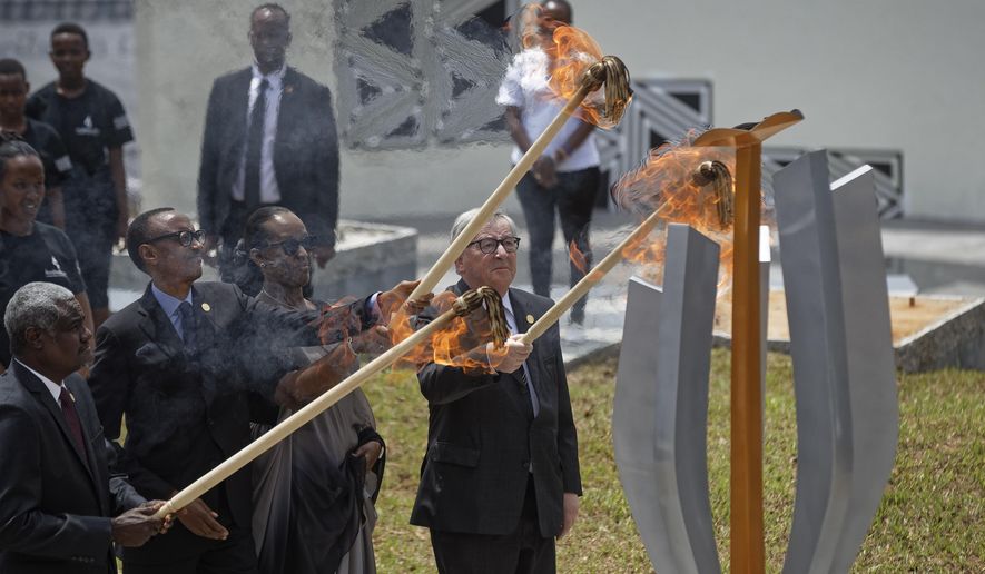 From left to right, Chairperson of the African Union Commission Moussa Faki Mahamat, Rwanda&#39;s President Paul Kagame, Rwanda&#39;s First Lady Jeannette Kagame, and President of the European Commission Jean-Claude Juncker, light the flame of remembrance at the Kigali Genocide Memorial in Kigali, Rwanda, Sunday, April 7, 2019.  Rwanda is commemorating the 25th anniversary of when the country descended into an orgy of violence in which some 800,000 Tutsis and moderate Hutus were massacred by the majority Hutu population over a 100-day period in what was the worst genocide in recent history. (AP Photo/Ben Curtis)