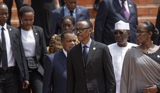 Rwanda&#39;s President Paul Kagame, center, and First Lady Jeannette Kagame, right, arrive at the Kigali Genocide Memorial in Kigali, Rwanda Sunday, April 7, 2019. Rwanda is commemorating the 25th anniversary of when the country descended into an orgy of violence in which some 800,000 Tutsis and moderate Hutus were massacred by the majority Hutu population over a 100-day period in what was the worst genocide in recent history. (AP Photo/Ben Curtis)