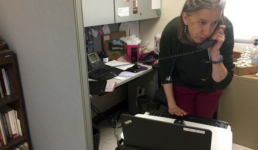 FILE - In this Dec. 21, 2016, file photo, family physician Leslie Hayes listens for a fetal heartbeat while attending to a 40-year-old mother, not seen, who is being treated for an addiction to heroin with the anti-craving medication Subutext, at the El Centro Family Health medical clinic in Espanola, N.M. "The Providers," set to air on the PBS Independent Lens series this week, looks at the challenges three health care workers in rural New Mexico face as they give services to aging patients and those struggling with addiction. (AP Photo/Morgan Lee, File)
