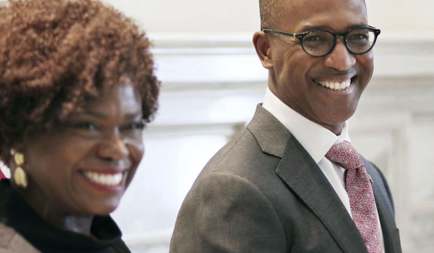 FILE - In this March 1, 2019 file photo Eric Stevenson stands with his wife Davia in the Blue Room at the Capitol in Oklahoma City, Okla. Gov. The Oklahoma Senate has confirmed Gov. Kevin Stitt's pick of Stevenson, the first African American to serve on the University of Oklahoma Board of Regents in 20 years. The Senate voted 45-1 on Monday to confirm Stevenson, an Ohio business executive. (Doug Hoke/The Oklahoman via AP, File)