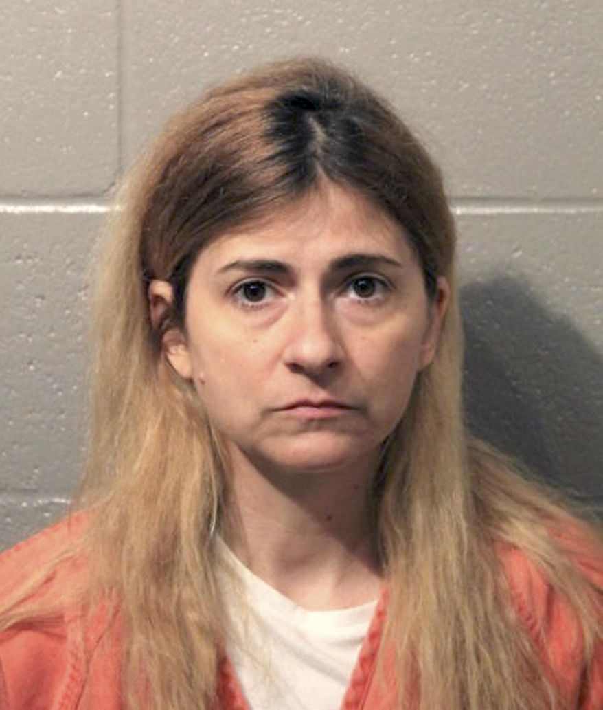 This Monday, April 8, 2019, booking photo provided by the Cleveland County Sheriff's Office shows 45-year-old Allison Christine Johnson of Norman, Ok., who is suspected of spray painting racist, anti-gay and anti-Semitic graffiti on Democratic Party offices in Norman and Oklahoma City. Court records indicate Johnson was charged in Cleveland County Monday with one felony and three misdemeanor counts of malicious injury to property and one misdemeanor count of malicious intimidation or harassment. (Cleveland County Sheriff's Office via AP)