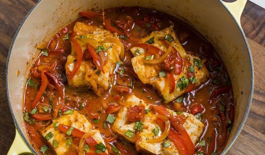 This undated photo provided by America's Test Kitchen in March 2019 shows Braised Cod Peperonata in Brookline, Mass. This recipe appears in the book "Cook It in Your Dutch Oven." (Steve Klise/America's Test Kitchen via AP)