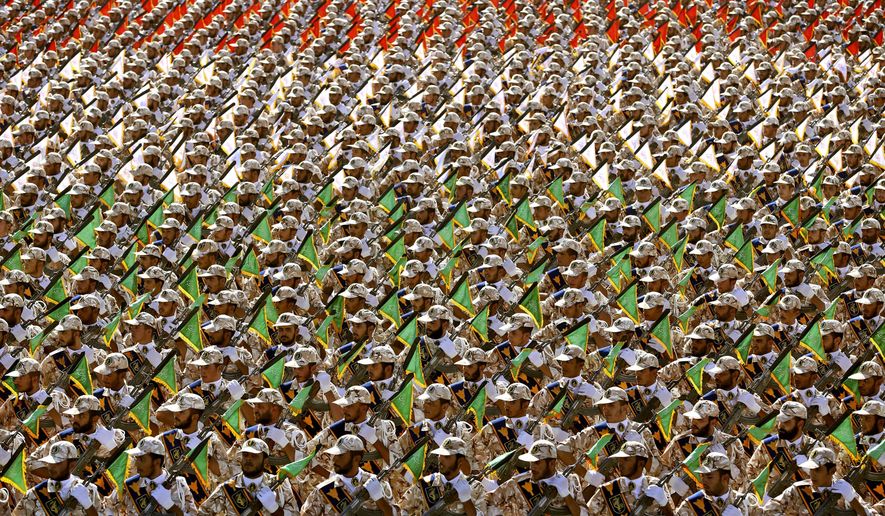 In this Sept. 22, 2014 file photo, members of the Iran's Revolutionary Guard march during an annual military parade at the mausoleum of Ayatollah Khomeini, outside Tehran, Iran. On Monday, April 8, 2019, the Trump administration designated Iran’s Revolutionary Guard a “foreign terrorist organization” in an unprecedented move against a national armed force. Iran’s Revolutionary Guard Corps went from being a domestic security force with origins in the 1979 Islamic Revolution to a transnational fighting force. (AP Photo/Ebrahim Noroozi, File)