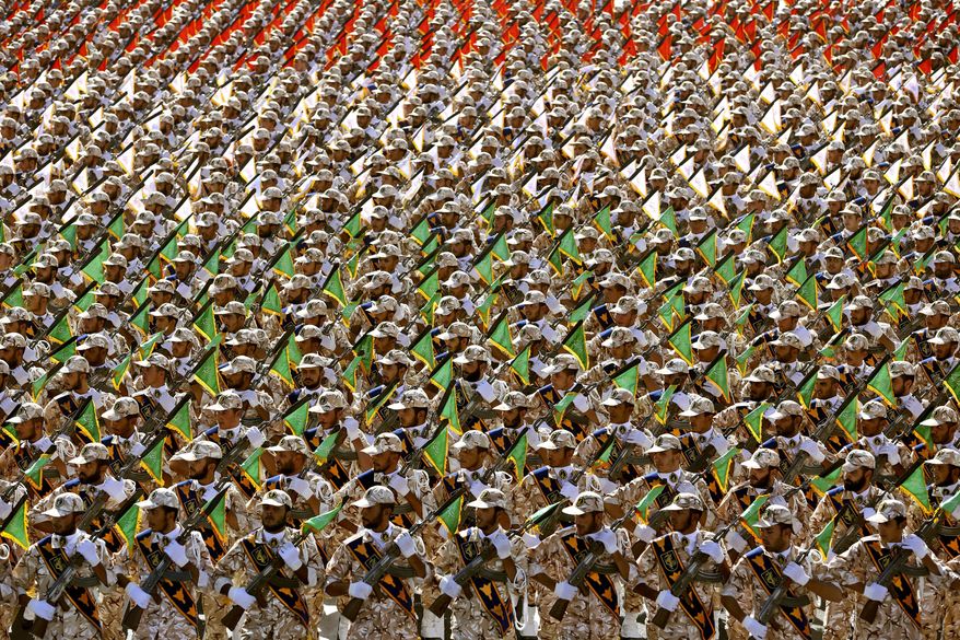 In this Sept. 22, 2014 file photo, members of the Iran&#39;s Revolutionary Guard march during an annual military parade at the mausoleum of Ayatollah Khomeini, outside Tehran, Iran. On Monday, April 8, 2019, the Trump administration designated Iran’s Revolutionary Guard a “foreign terrorist organization” in an unprecedented move against a national armed force. Iran’s Revolutionary Guard Corps went from being a domestic security force with origins in the 1979 Islamic Revolution to a transnational fighting force. (AP Photo/Ebrahim Noroozi, File)