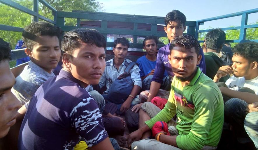 In this undated handout photo released April 8, 2019, dozens of people believed to be Rohingya Muslims from Myanmar who were dropped off from a boat are pictured on a truck before being taken to a police station near Sungai Belati, Perlis, Malaysia. Malaysian police say a group of 41 Muslim Rohingya men have been detained in the northernmost state of Perlis, the second batch to have landed in the country in just over a month. (Malaysia Royal Police via AP)
