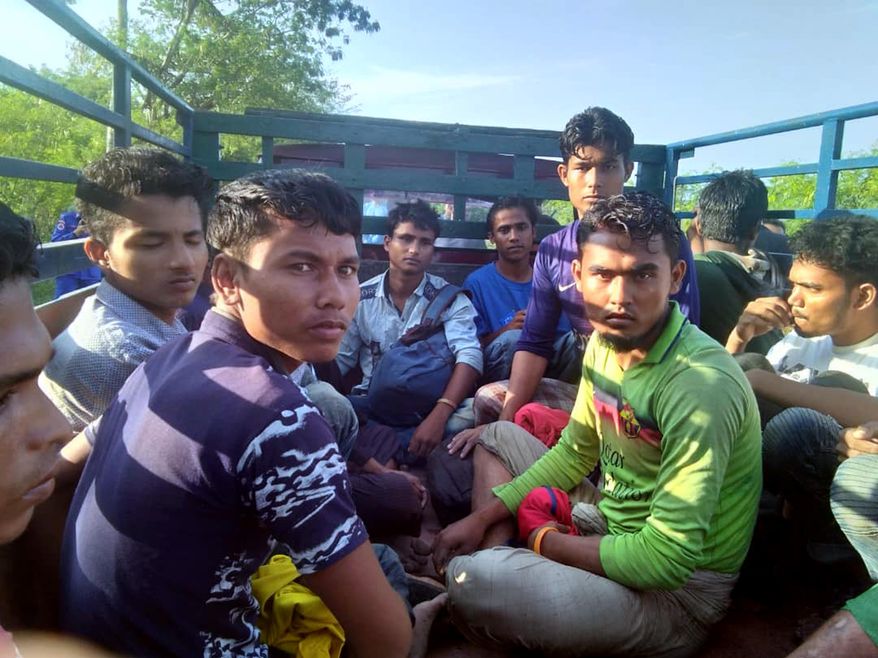 In this undated handout photo released April 8, 2019, dozens of people believed to be Rohingya Muslims from Myanmar who were dropped off from a boat are pictured on a truck before being taken to a police station near Sungai Belati, Perlis, Malaysia. Malaysian police say a group of 41 Muslim Rohingya men have been detained in the northernmost state of Perlis, the second batch to have landed in the country in just over a month. (Malaysia Royal Police via AP)
