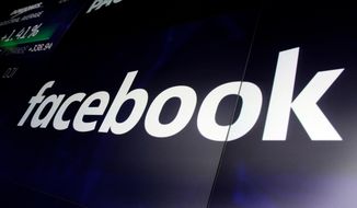 In this March 29, 2018, photo, the logo for Facebook appears on screens at the Nasdaq MarketSite, in New York&#39;s Times Square. New Zealand’s official privacy watchdog has described Facebook as “morally bankrupt” and suggested his country follow neighboring Australia’s lead by making laws that could jail executives over streamed violence such as the Christchurch mosque shootings. (AP Photo/Richard Drew, File)