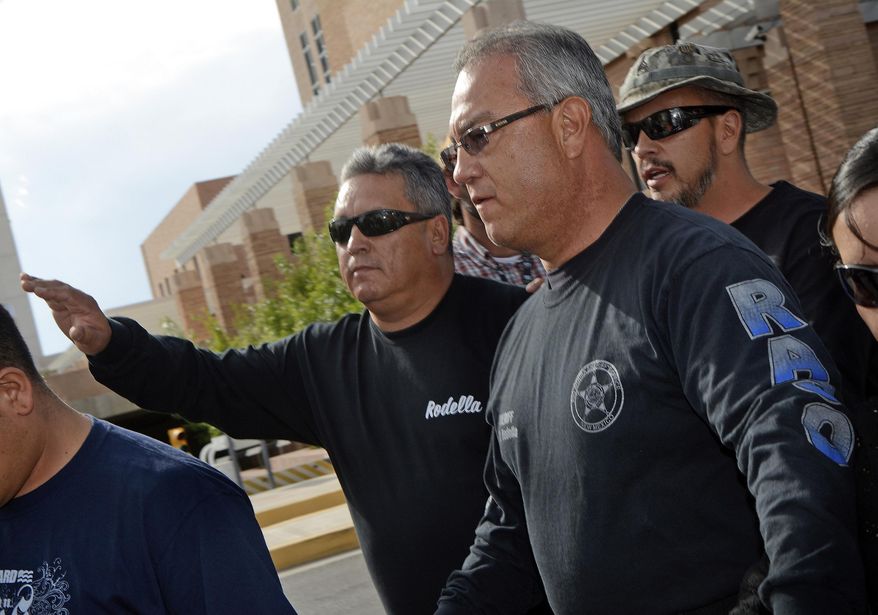 FILE - In this Aug. 12, 2014, file photo, former Rio Arriba County Sheriff Thomas Rodella, center, leaves the U.S. Federal Courthouse in Albuquerque, N.M. during his trial over a violent road rage episode. Rodella, who is serving a 10-year federal prison term, in March 2019, filed a motion to vacate his sentence over claims his attorney failed to provide an effective defense. (Jim Thompson/The Albuquerque Journal via AP, File)