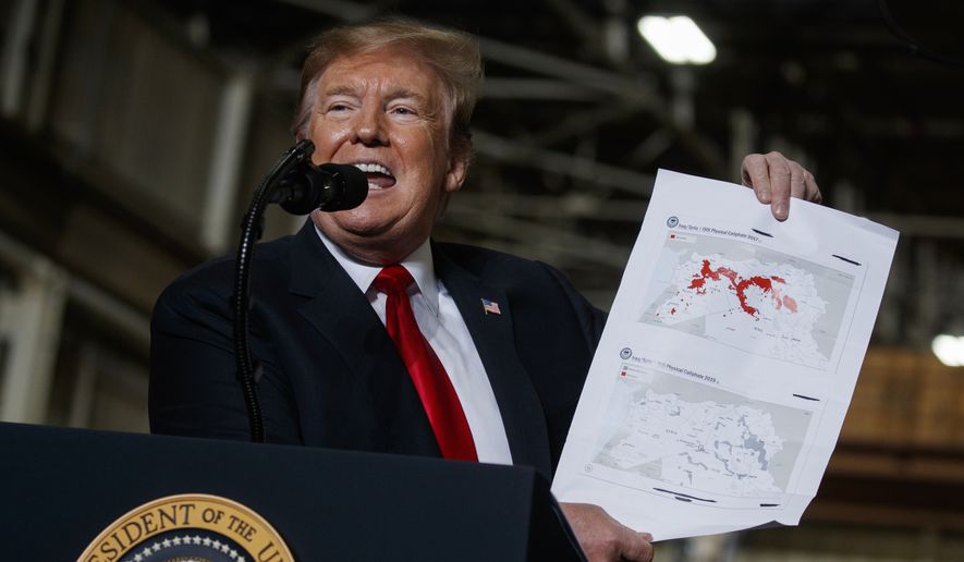 President Donald Trump holds up a chart documenting ISIS land loss in Iraq and Syria as delivers remarks at the Lima Army Tank Plant, Wednesday, March 20, 2019, in Lima, Ohio. In a campaign that spanned five years and two U.S. presidencies, the American military engineered the destruction of the Islamic State group’s self-proclaimed empire in Iraq and Syria. That’s a military success, but not one that’s certain to last. (AP Photo/Evan Vucci)