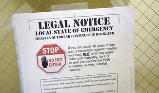 FILE - This Wednesday, March 27, 2019 file photo shows a sign explaining the local state of emergency because of a measles outbreak at the Rockland County Health Department in Pomona, N.Y. Measles is spread through the air when an infected person coughs or sneezes. It&#x27;s so contagious that 90 percent of people who aren&#x27;t immunized are infected if exposed to the virus, according to the Centers for Disease Control and Prevention. (AP Photo/Seth Wenig)