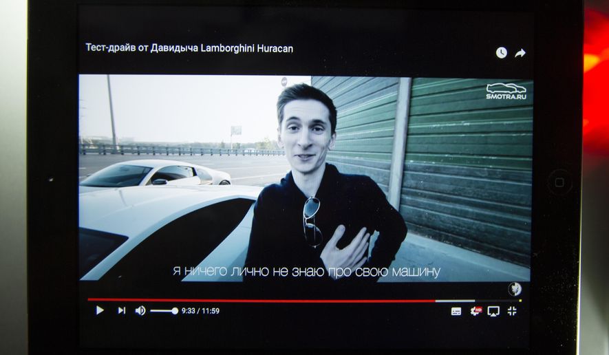 FILE - In this Tuesday, July 25, 2017 file photo, a tablet shows archive Youtube footage dated Monday, Aug. 2, 2015 featuring Yevgeny Nikulin after a Lamborghini Huracan race outside Moscow, Russia. The Czech Republic&#x27;s highest court has ruled on Tuesday, April 9, 2019 that a former justice minister violated the rights of a Russian man by allowing his extradition to the United States to face charges of hacking computers at LinkedIn, Dropbox and other American companies. (AP Photo/Alexander Zemlianichenko/File)