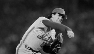 In this Oct, 22, 1986, file photo, New York Mets&#x27; Ron Darling pitches against the Boston Red Sox in the first inning of Game 4 of the World Series at Boston&#x27;s Fenway Park. Lenny Dykstra has sued former Mets teammate Darling, St. Martin&#x27;s Press and Macmillan Publishing Group over a passage in the pitcher&#x27;s new book accusing the outfielder of directing racist comments toward Boston pitcher Oil Can Boyd during the 1986 World Series. (AP Photo/Elise Amendola, File) **FILE**