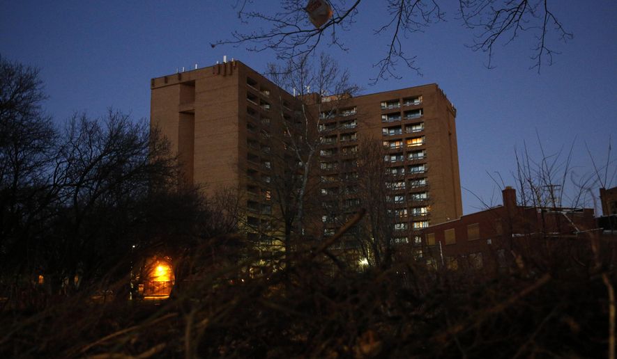 In this Feb. 25, 2019 photo, dusk settles over Rosemont Tower in Baltimore. Health and safety inspectors gave the 200-unit public housing high-rise a failing score of 25 out of a possible 100 in 2017. The score improved to 71 last year, according to housing authority officials. (AP Photo/Patrick Semansky)
