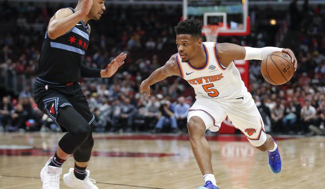 New York Knicks guard Dennis Smith Jr. (5) drives to the basket against Chicago Bulls guard Timothe Luwawu-Cabarrot during the first half of an NBA basketball game Tuesday, April 9, 2019, in Chicago. (AP Photo/Kamil Krzaczynski)