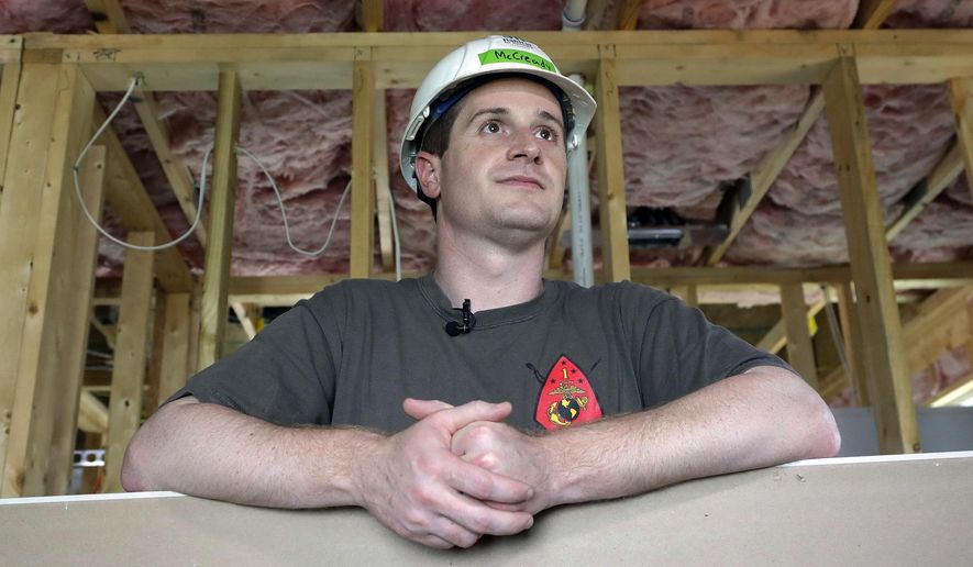 FILE - In this Sept. 26, 2018, file photo, Democratic congressional candidate Dan McCready leans against a wallboard as he pauses during a Habitat For Humanity building event in Charlotte, N.C. The Democratic North Carolina congressional candidate says he has raised more than $1.6 million in campaign funds for a special election that was forced after last year’s race was voided by a ballot-collection scandal. McCready’s campaign said Tuesday, Apri 9, 2019, that the 9th District candidate also ended the year’s first quarter with $1.46 million in cash on hand. (AP Photo/Chuck Burton, File)