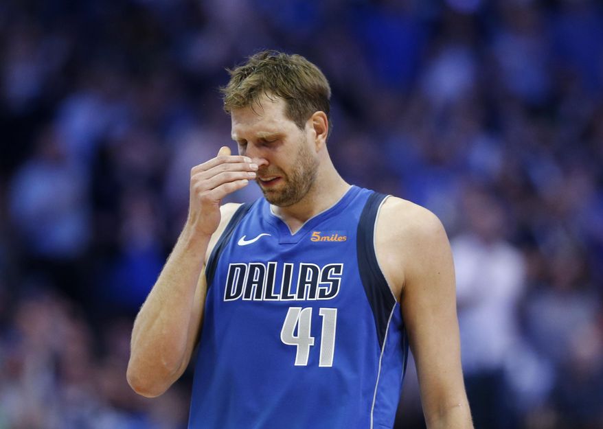 Dallas Mavericks forward Dirk Nowitzki gets emotional after a video played during a break in the first half of the team&#39;s NBA basketball game against the Phoenix Suns in Dallas on Tuesday, April 9, 2019. (Vernon Bryant/The Dallas Morning News via AP)