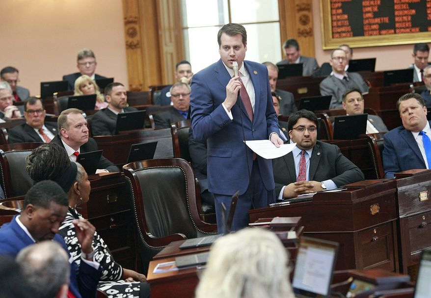 Ohio Rep. Derek Merrin stands while he advocates a yes vote on the Heartbeat Bill at the Ohio Statehouse in Columbus, Ohio on Wednesday, April 10, 2019. The House members voted in the controversial "Heartbeat Bill" that bans abortion at the first sounds of a fetal heartbeat, which is around 6 weeks after conception. Many protestors shouted in the hallway outside of the meeting where House members decided to pass the bill. (Brooke LaValley/The Columbus Dispatch via AP)