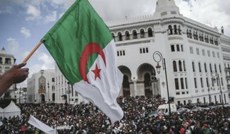 People chant slogans and wave flags during a demonstration in Algiers, Algeria, Wednesday, April 10, 2019. The Algerian senator Abdelkader Bensalah named to temporarily fill the office vacated by former President Abdelaziz Bouteflika said he would act quickly to arrange an &amp;quot;honest and transparent&amp;quot; election to usher in an &amp;quot;Algeria of the future.&amp;quot; (AP Photo/Mosa&#39;ab Elshamy)