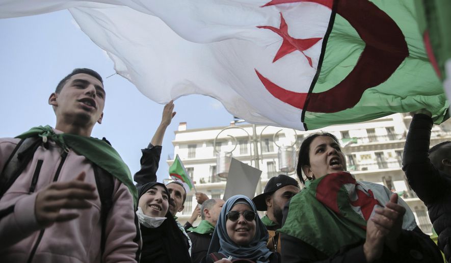 People chant slogans during a demonstration in Algiers, Algeria, Wednesday, April 10, 2019. Thousands took to the streets rejecting the country's interim leader Abdelkader Bensalah, an ally of former President Abdelaziz Bouteflika. (AP Photo/Mosa'ab Elshamy)