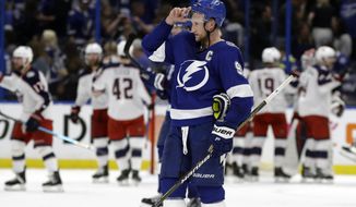 Tampa Bay Lightning center Steven Stamkos (91) skates off as the Columbus Blue Jackets celebrate their 4-3 win during Game 1 of an NHL Eastern Conference first-round hockey playoff series Wednesday, April 10, 2019, in Tampa, Fla. (AP Photo/Chris O&#39;Meara)