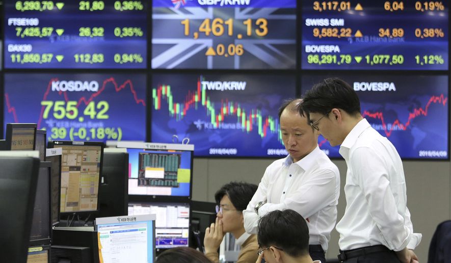 Currency traders work at the foreign exchange dealing room of the KEB Hana Bank headquarters in Seoul, South Korea, Wednesday, April 10, 2019. Asian shares fell Wednesday following a slide on Wall Street amid growing tensions between the U.S. and the European Union and a dim forecast on global economic growth.(AP Photo/Ahn Young-joon)