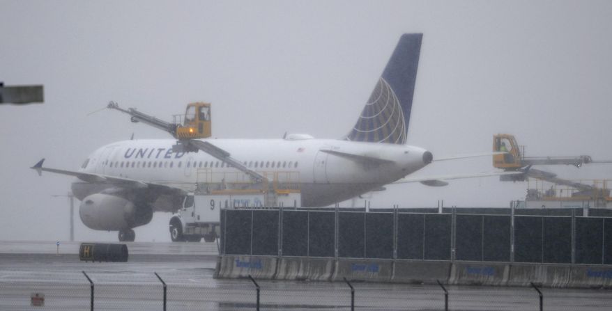 A United Airlines plane is deiced before taking off from Denver International Airport Wednesday, April 10, 2019, in Denver. Forecasters are predicting from four to 10 inches of snow for northeastern Colorado as the storm sweeps over the intermountain West Wednesday evening and into Thursday. (AP Photo/David Zalubowski)