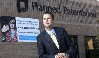 File - This Jan. 23, 2011, file photo, shows Bryan Howard, president of Planned Parenthood Arizona, in front of one of the group&#39;s offices in Tucson, Ariz. Planned Parenthood Arizona filed a lawsuit on Thursday, April 11, 2019, that challenges several Arizona laws that it says leave most rural areas in the state without any nearby abortion clinics. (AP Photo/Ross D. Franklin, File)
