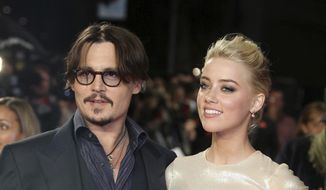 In this Nov. 3, 2011, file photo, U.S. actors Johnny Depp, left, and Amber Heard arrive for the European premiere of their film, &amp;quot;The Rum Diary,&amp;quot; in London. Heard is asking a judge to dismiss a $50 million defamation lawsuit her ex-husband Johnny Depp filed over a Washington Post op-ed she wrote about domestic violence. (AP Photo/Joel Ryan, File)