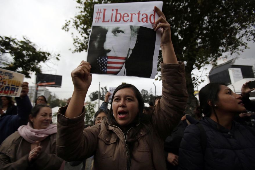 A woman holds up the Spanish hashtag #Freedom during a protest against the arrest of WikiLeaks founder Julian Assange, outside the Foreign Ministry in Quito, Ecuador, Thursday, April 11, 2019. On Thursday, Ecuador's President Lenin Moreno allowed British authorities to forcibly remove Assange from Ecuador’s small embassy in London where he was given safe haven in 2012. (AP Photo/Dolores Ochoa)