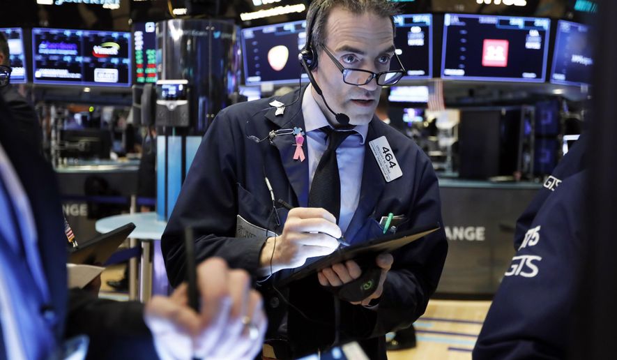 FILE- In this March 5, 2019, file photo trader Gregory Rowe works on the floor of the New York Stock Exchange. The U.S. stock market opens at 9:30 a.m. EDT on Thursday, April 11. (AP Photo/Richard Drew, File)