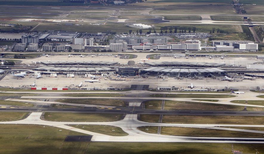 FILE - This June 23, 2011 aerial file photo shows Roissy Charles De Gaulle hub 2, north of Paris. French opposition lawmakers from the right and the left are joining efforts to try to block the government&#39;s plan to privatize Paris airports. (AP Photo/Francois Mori, File)