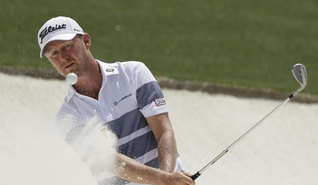 Justin Harding, of South Africa, hits from a bunker on the 18th hole during the first round for the Masters golf tournament Thursday, April 11, 2019, in Augusta, Ga. (AP Photo/Marcio Jose Sanchez)