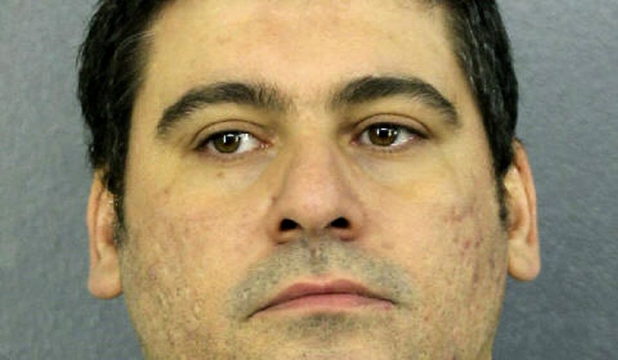 This Tuesday, April 10, 2019 photo made available by Broward County Sheriff's office, Fla., shows Luis Alberto Ferri under arrest. Ferri turned himself in to authorities less than a week after investigators released a video showing him intentionally driving his vehicle into a pedestrian. The victim suffered a broken leg. Ferri is charged with aggravated battery. (Broward County Sheriff's office via AP)