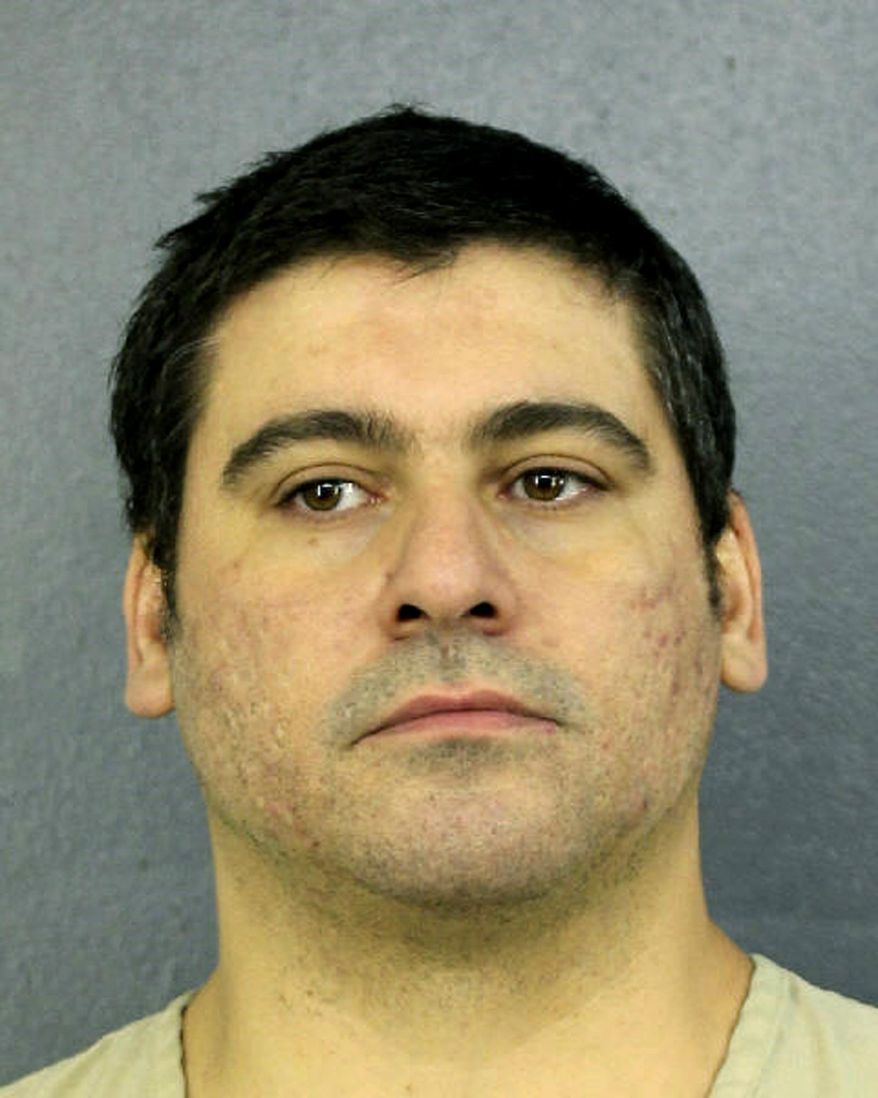 This Tuesday, April 10, 2019 photo made available by Broward County Sheriff's office, Fla., shows Luis Alberto Ferri under arrest. Ferri turned himself in to authorities less than a week after investigators released a video showing him intentionally driving his vehicle into a pedestrian. The victim suffered a broken leg. Ferri is charged with aggravated battery. (Broward County Sheriff's office via AP)
