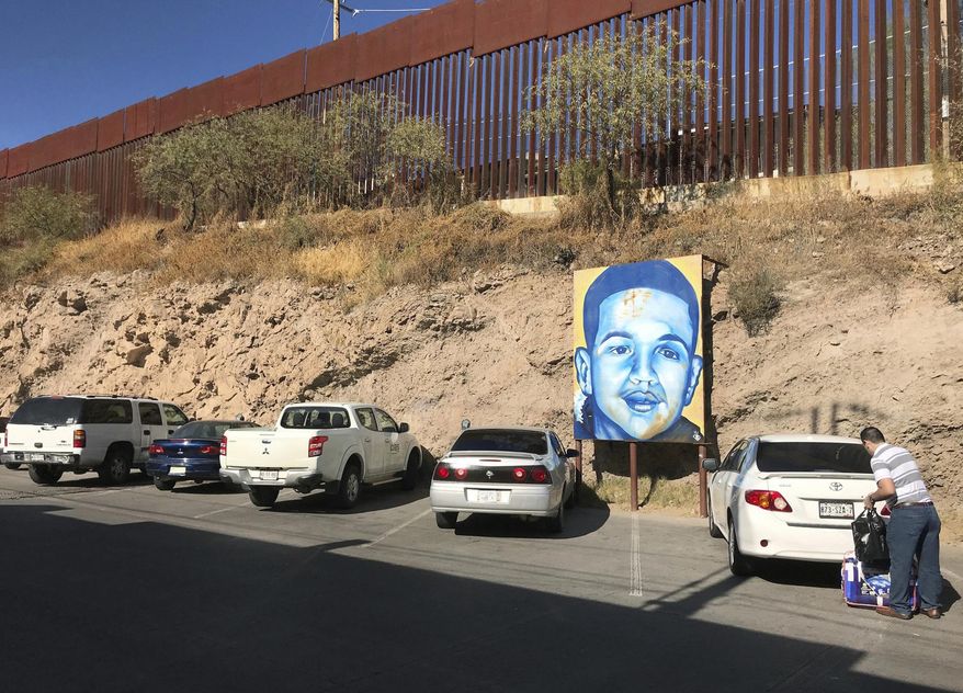 FILE - In this Dec. 4, 2017, file photo, a portrait of 16-year-old Mexican youth Jose Antonio Elena Rodriguez, who was shot and killed in Nogales, Sonora, Mexico, is displayed on the Nogales street where he was killed that runs parallel with the U.S. border. The Trump administration says families of Mexican teenagers who were shot to death by American border agents should not be allowed to sue for damages in U.S. courts. The administration is telling the Supreme Court in a brief filed April 11, 2019, that the justices should take up and resolve the issue in favor of two agents who fired shots across the U.S-Mexican border that killed the teenagers. (AP Photo/Anita Snow, File)