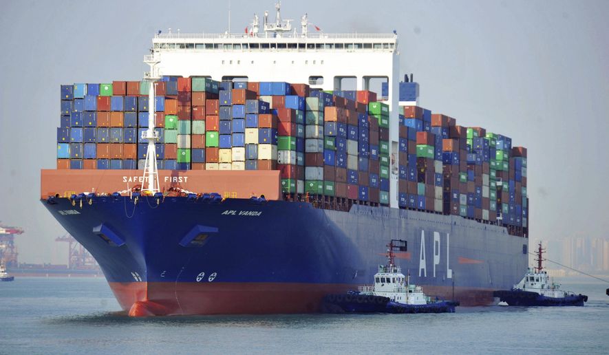 In this April 1, 2019, photo, tugboats move a container ship at a port in Qingdao in eastern China's Shandong Province. Data released Friday, April 12, 2019, shows that China's exports rebounded from a contraction in March and sales to the United States grew strongly despite President Donald Trump's tariff hikes.(Chinatopix via AP)