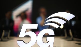 FILE - This Feb. 25, 2019 file photo shows a banner of the 5G network is displayed during the Mobile World Congress wireless show, in Barcelona, Spain.  The U.S. communications regulator will hold a massive auction to bolster 5G service, the next generation of mobile networks, and will spend $20 billion for rural internet.  5G will mean faster wireless speeds and has implications for technologies like self-driving cars and augmented reality.   The Federal Communications Commission said Friday, April 12,  that it would hold the largest auction in U.S. history, of 3,400 megahertz, to boost wireless companies’ networks.  (AP Photo/Manu Fernandez, File)