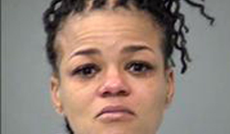 This undated photo provided by the Indianapolis Metropolitan Police Department shows Tiffany White. White is charged with neglect of a dependent causing death, unlawful possession of a firearm by a serious violent felon, possession of cocaine and possession of a controlled substance. She's being held in the Marion County Jail. Police arrested White, the mother an 8-year-old girl who died after her father brought her to an Indianapolis fire station with a gunshot wound. Police say Kendrielle Brye died March 24, 2019, in an Indianapolis hospital. They say the girl did not shoot herself. (Indianapolis Metropolitan Police Department via AP)