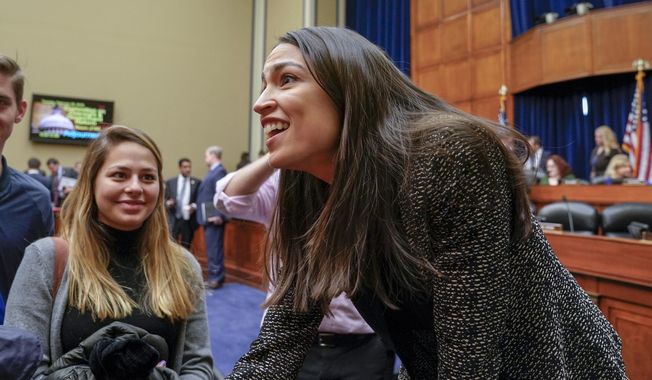Rep. Alexandria Ocasio-Cortez, D-N.Y., speaks to visiting students following a House Oversight and Reform Committee meeting, on Capitol Hill in Washington, Tuesday, Feb. 26, 2019. House Democrats are rounding the first 100 days of their new majority taking stock of their accomplishments, noting the stumbles and marking their place as a frontline of resistance to President Donald Trump. (AP Photo/J. Scott Applewhite)