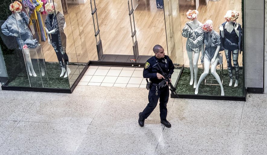 Responding to a call of shots fired, a Monroeville Police officer patrols the Monroeville Mall, Friday, April 12, 2019, in Monroeville, Pa. (Alexandra Wimley/Pittsburgh Post-Gazette via AP)